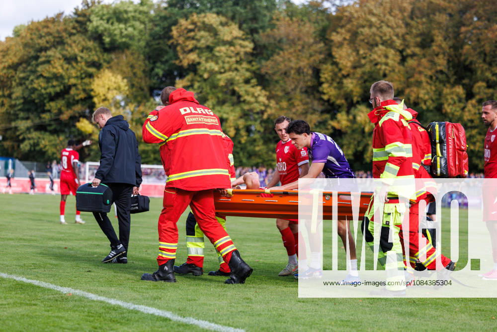 Janis Juckel of Greifswald has to be carried off the field on a stretcher after being injured. In the middle, Maxim Burghardt of Aue apologizes. GER, Greifswalder FC vs. FC Erzgebirge Aue, Soccer, Men, Northeast Regional League, Matchday 12, 2026–2027 season, October 11, 2026, Greifswald Volksstadion, Mecklenburg-Western Pomerania, Germany