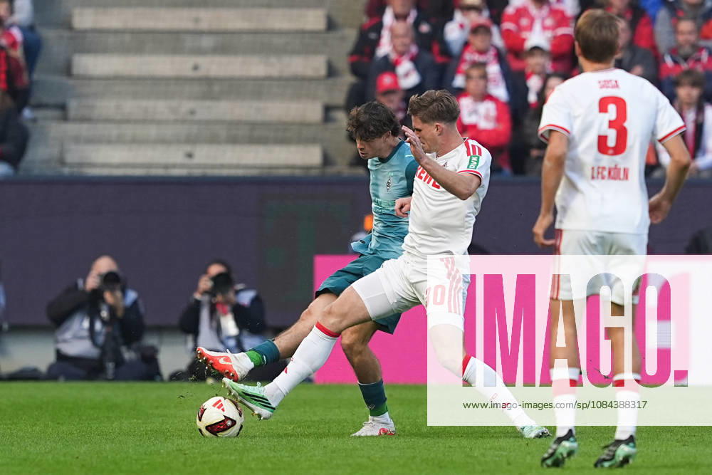 Men s, Soccer, Bundesliga 1, 1. FC Köln vs. Borussia Mönchengladbach, 2026–2027 season, RheinEnergieSTADION, Philipp Sander, Borussia Mönchengladbach, No. 16 in a tackle against Marius Buelter of 1. FC Köln, No. 30. DFB regulations prohibit any use of photographs as image sequences and or quasi-video.