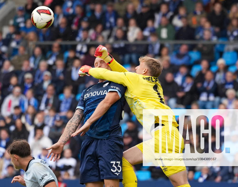 Jonas Thomas Kersken of DSC Arminia Bielefeld, No. 1, makes contact with Philipp Hofmann of VfL Bochum 1848, No. 33 (GER), while punching the ball away, VfL Bochum 1848 vs. DSC Arminia Bielefeld, 2. Bundesliga, Matchday 7, 2026–27 season, Vonovia Ruhrstadion, Bochum, October 11, 2026 DFL REGULATIONS PROHIBIT ANY USE OF PHOTOGRAPHS AS IMAGE SEQUENCES AND OR QUASI-VIDEO VfL Bochum 1848 vs. DSC Arminia Bielefeld, 2. Bundesliga, Matchday 7, 2026–27 Season, October 11, 2026, Bochum