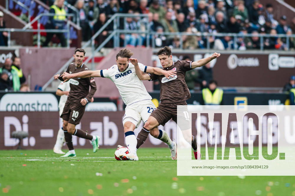2. Bundesliga: FC St. Pauli vs. Karlsruher SC, October 11, 2026; Christoph Kobald (Karlsruher SC), No. 22, against Arkadiusz Pyrka (FC St. Pauli), No. 11, in a tackle during a soccer match, 2. Bundesliga, Matchday 7: FC St. Pauli vs. Karlsruher SC on October 11, 2026, at Millerntor Stadium, Hamburg. DFL regulations prohibit any use of photographs as image sequences and or quasi-video.