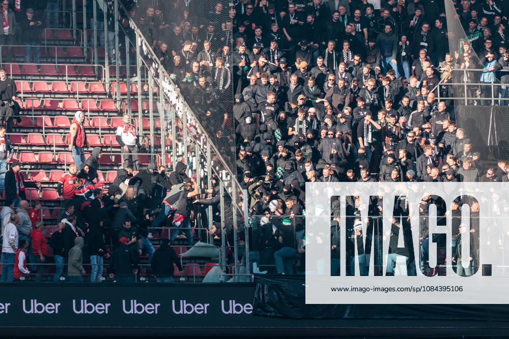 Fans of both Borussia Moenchengladbach and 1. FC Koeln going at each other through broken glass during the Bundesliga match between 1. FC Koeln vs. Borussia Moenchengladbach at Rheinenergie-Stadion on matchday 5 of the 1. Bundesliga on October 11, 2026 in Koeln, Germany. DFL REGULATIONS PROHIBIT ANY USE OF PHOTOGRAPHS AS IMAGE SEQUENCES AND OR QUASI-VIDEO. North Rhine Westphalia Germany