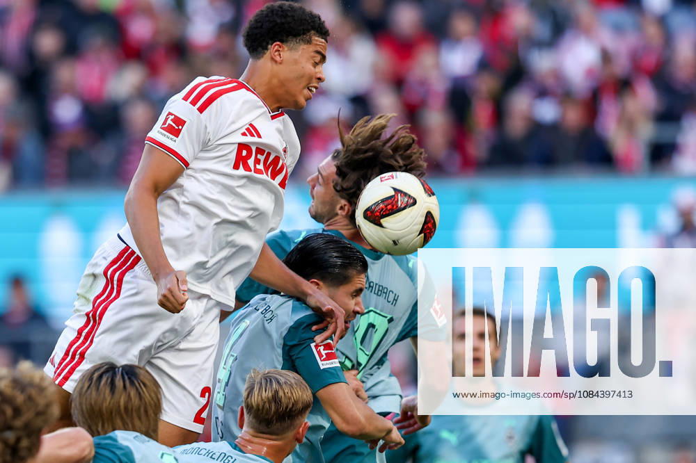 Soccer, Bundesliga, 1. FC Köln vs. Borussia Mönchengladbach, RheinEnergieSTADION, Matchday 5, 2026–2027 season: Jahmai Simpson Pusey (1 FC Köln, No. 22) in an aerial duel amid the scramble against Nicolas Kuehn (Borussia Mönchengladbach, No. 19) and Kevin Diks (Borussia Mönchengladbach, No. 4). DFB regulations prohibit any use of photographs as image sequences and or quasi-video. Photo: WilkowskixPressefotoKochx, North Rhine-Westphalia, Germany