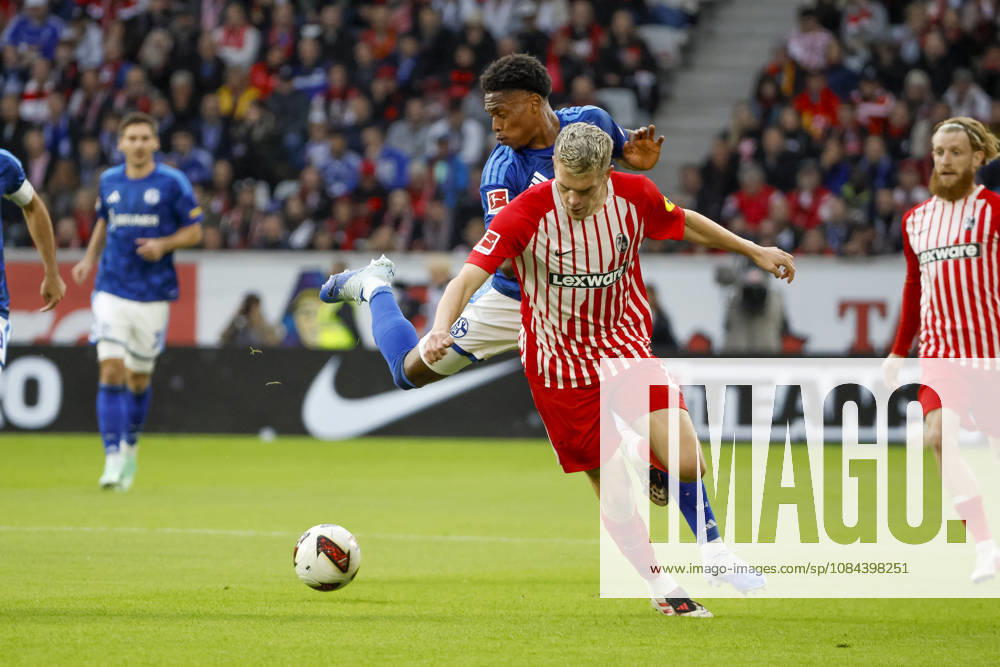 Junior Adamu of FC Schalke, 20, and Matthias Ginter of SC Freiburg, 28, in a tackle, Germany, soccer, Bundesliga 1, Matchday 5, 2026–2027, SC Freiburg vs. FC Schalke 04, October 11, 2026, Freiburg im Breisgau, Europa-Park Stadium, Germany