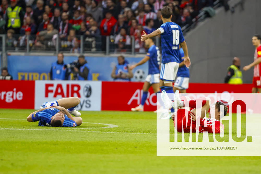 Hasan Kurucay (FC Schalke 04) and Yuito Suzuki (SC Freiburg) are injured on the ground, Germany, soccer, Bundesliga 1, Matchday 5, 2026–2027, SC Freiburg vs. FC Schalke 04, October 11, 2026, Freiburg im Breisgau, Europa-Park Stadium, Germany