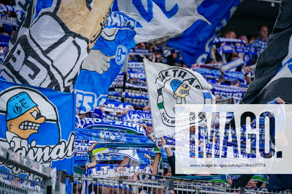 Germany Soccer Bundesliga 2026–2027, Matchday 5: SC Freiburg vs. FC Schalke 04 at Europa-Park Stadium in Freiburg. Close-up of numerous FC Schalke 04 fans in the visitors’ section during the away game against SC Freiburg at Europa-Park Stadium. Blue-and-white waving flags featuring motifs of the Ultras Gelsenkirchen and fans holding up scarves Schalke 04, S04, Royal Blue, Ultras Gelsenkirchen, UGE, Ultras, visiting fans, away fans, fan scene, fan culture, fan section, away section, scarf parade, sea of flags, fan flags, waving flags, fan merchandise, spectators, stands, Bundesliga, soccer, stadium, interior view