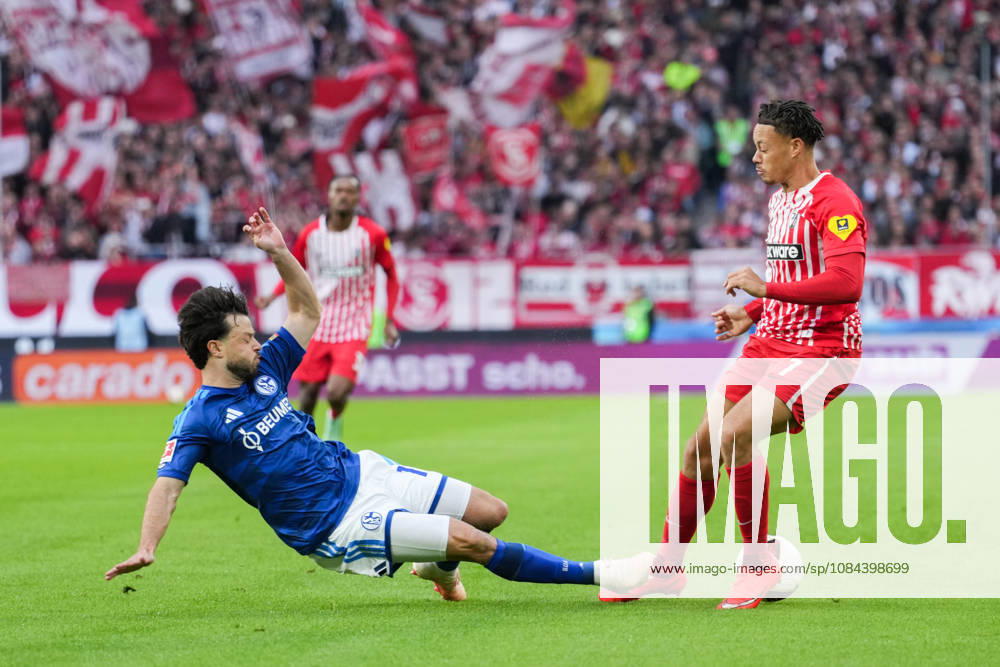 1 Bundesliga: SC Freiburg vs. FC Schalke 04, October 11, 2026; Tackle between Adrian Gantenbein (FC Schalke 04, No. 17) and Derry Scherhant (SC Freiburg, No. 7); 1 Bundesliga: SC Freiburg vs. FC Schalke 04, Europa-Park Stadium, October 11, 2026 DFB and DFL regulations prohibit any use of photographs as image sequences and or quasi-video.