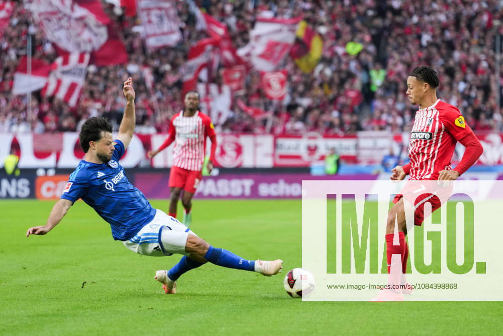 1 Bundesliga: SC Freiburg vs. FC Schalke 04, October 11, 2026—A tackle between Adrian Gantenbein (FC Schalke 04, No. 17) and Derry Scherhant (SC Freiburg, No. 7). 1 Bundesliga: SC Freiburg vs. FC Schalke 04, Europa-Park Stadium, October 11, 2026 DFB and DFL regulations prohibit any use of photographs as image sequences and or quasi-video.