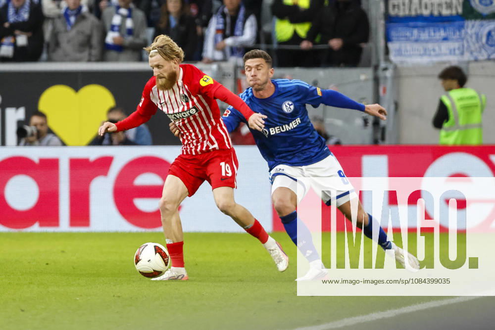Niklas Beste of SC Freiburg, 19, and Robin Gosens of FC Schalke 08 in a tackle, Germany, soccer, Bundesliga 1, Matchday 5, 2026–2027, SC Freiburg vs. FC Schalke 04, October 11, 2026, Freiburg im Breisgau, Europa-Park Stadium, Germany