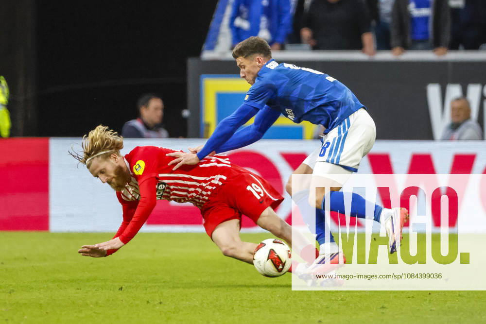 Niklas Beste of SC Freiburg, 19, and Robin Gosens of FC Schalke 08 in a tackle, Germany, soccer, Bundesliga 1, Matchday 5, 2026–2027, SC Freiburg vs. FC Schalke 04, October 11, 2026, Freiburg im Breisgau, Europa-Park Stadium, Germany