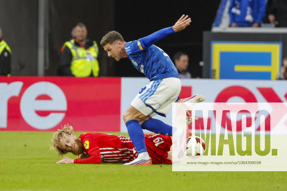 Niklas Beste of SC Freiburg, 19, and Robin Gosens of FC Schalke 08 in a tackle, Germany, soccer, Bundesliga 1, Matchday 5, 2026–2027, SC Freiburg vs. FC Schalke 04, October 11, 2026, Freiburg im Breisgau, Europa-Park Stadium, Germany