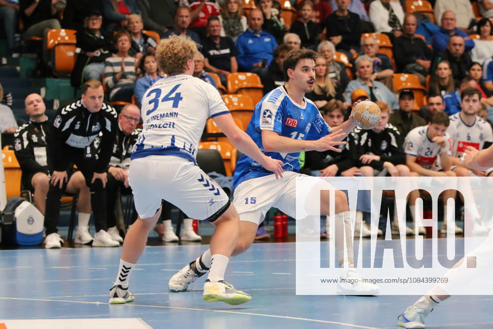Men s Handball 2026–2027, 2nd Division, Matchday 7: Dessau Roßlauer HV 06 vs. VfL Lübeck Schwartau at Anhalt Arena, Dessau. Marcel Nowak, Dessau, 15, in blue with the ball; Thore Heinemann, Lübeck, 34, in white, closes down the space; Dessau Roßlau, Saxony-Anhalt, Germany