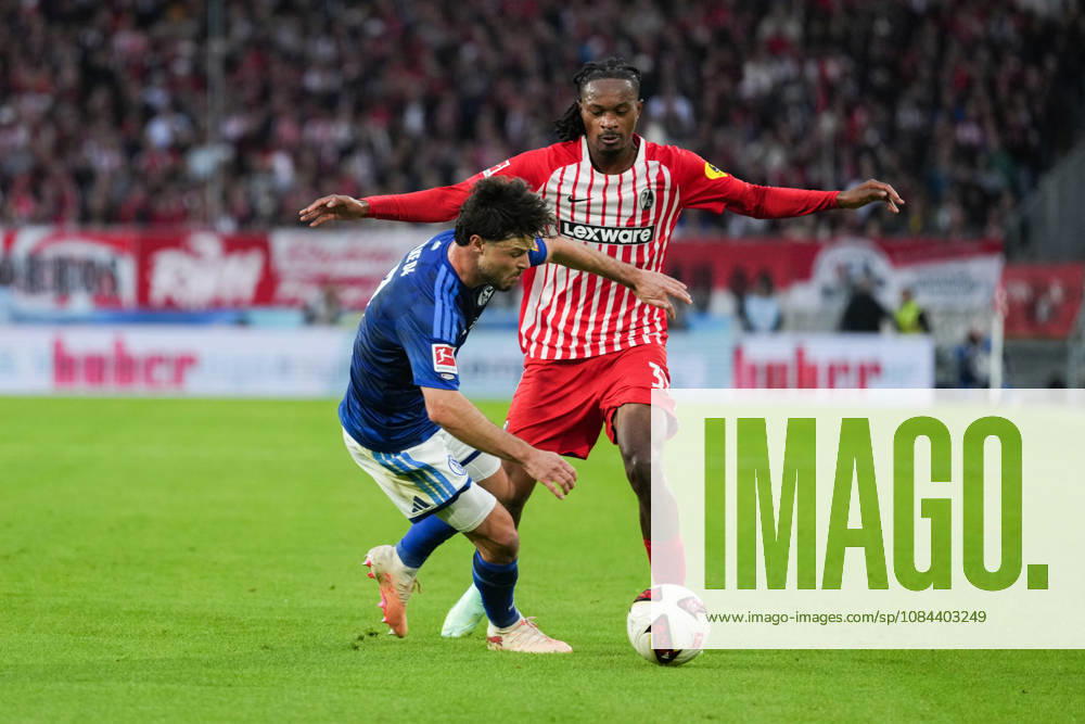1 Bundesliga: SC Freiburg vs. FC Schalke 04, October 11, 2026—A tackle between Adrian Gantenbein (FC Schalke 04, No. 17) and Jordy Makengo (SC Freiburg, No. 33). 1 Bundesliga: SC Freiburg vs. FC Schalke 04, Europa-Park Stadium, October 11, 2026 DFB and DFL regulations prohibit any use of photographs as image sequences and or quasi-video.