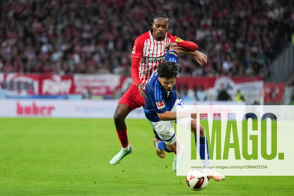 1 Bundesliga: SC Freiburg vs. FC Schalke 04, October 11, 2026—A tackle between Adrian Gantenbein (FC Schalke 04, No. 17) and Jordy Makengo (SC Freiburg, No. 33). 1 Bundesliga: SC Freiburg vs. FC Schalke 04, Europa-Park Stadium, October 11, 2026 DFB and DFL regulations prohibit any use of photographs as image sequences and or quasi-video.