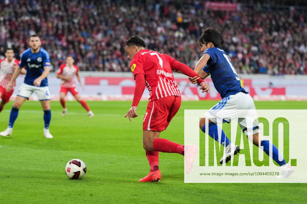 1 Bundesliga: SC Freiburg vs. FC Schalke 04, October 11, 2026—A tackle between Satoshi Tanaka (FC Schalke 04, No. 13) and Derry Scherhant (SC Freiburg, No. 7). 1 Bundesliga: SC Freiburg vs. FC Schalke 04, Europa-Park Stadium, October 11, 2026 DFB and DFL regulations prohibit any use of photographs as image sequences and or quasi-video.