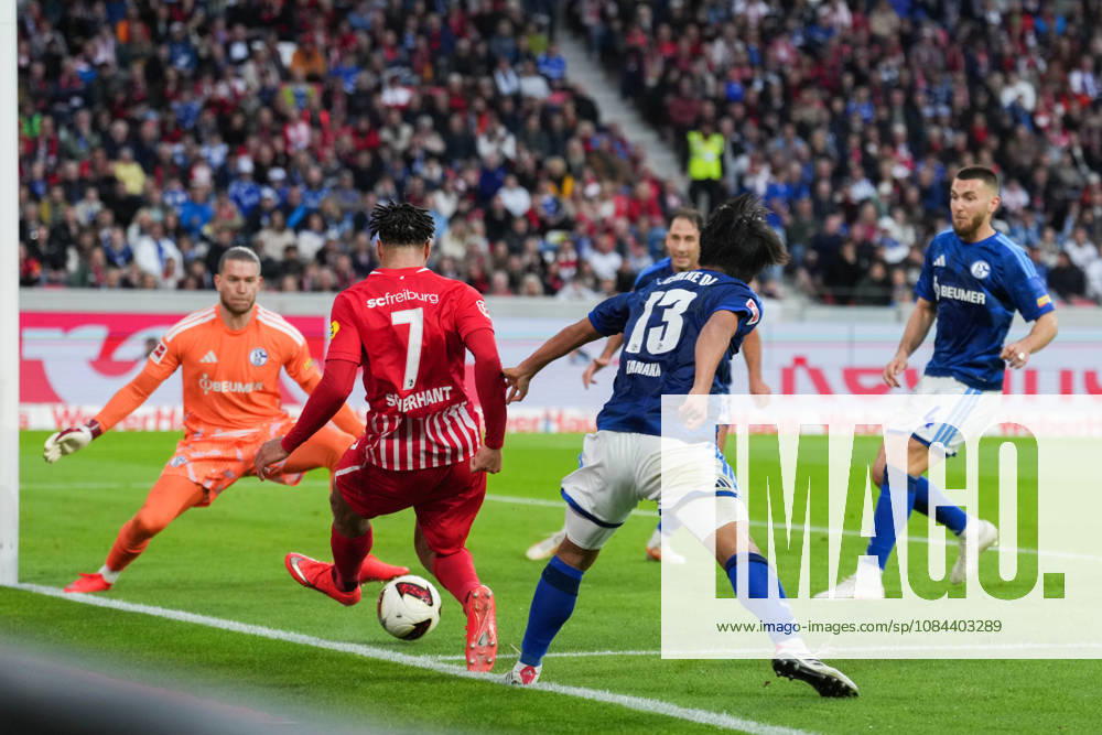 1 Bundesliga: SC Freiburg vs. FC Schalke 04, October 11, 2026—A tackle between Satoshi Tanaka (FC Schalke 04, No. 13) and Derry Scherhant (SC Freiburg, No. 7). 1 Bundesliga: SC Freiburg vs. FC Schalke 04, Europa-Park Stadium, October 11, 2026 DFB and DFL regulations prohibit any use of photographs as image sequences and or quasi-video.