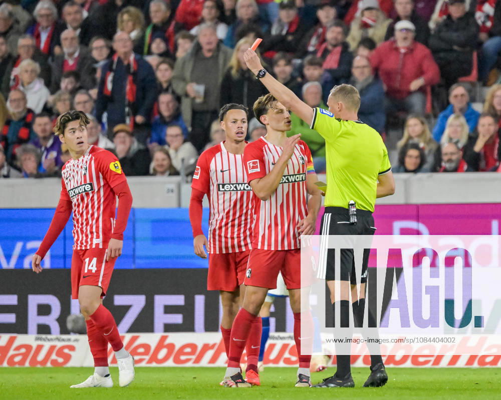 Referee Martin Petersen shows Yuito Suzuki of SC Freiburg, No. 14, a yellow-red card (GER), SC Freiburg vs. Schalke 04, Soccer, Bundesliga, Matchday 5, 2026–2027 season, October 11, 2026 DFL and DFB regulations prohibit any use of photographs as image sequences and or quasi-video GER, SC Freiburg vs. Schalke 04, Soccer, Bundesliga, Matchday 5, 2026–2027 Season, October 11, 2026, Freiburg