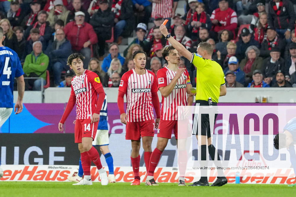 Referee Martin Petersen shows Yuito Suzuki of SC Freiburg, No. 14, a yellow-red card; Germany, soccer, Bundesliga 1, Matchday 5, 2026–2027, SC Freiburg vs. FC Schalke 04, October 11, 2026, Europa-Park Stadium, Freiburg, Baden-Württemberg, Germany