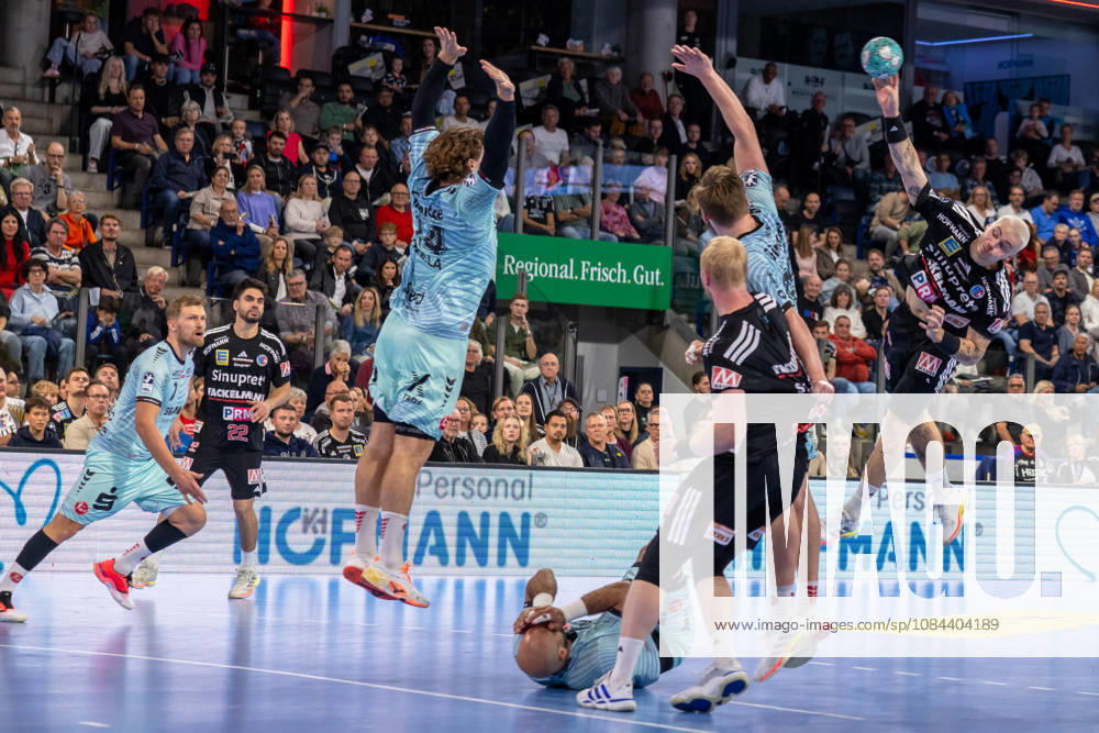 Marek Nissen (HC Erlangen, 06) shoots over the block set by Johannes Golla (MT Melsungen, 14) and Adrian Sipos (MT Melsungen, 08) on the floor. GER, HC Erlangen vs. MT Melsungen, Handball, Opel Handball Bundesliga, Matchday 8, 2026–2027 season, October 11, 2026, GER, HC Erlangen vs. MT Melsungen, Handball, Opel Handball Bundesliga, Matchday 8, 2026–2027 season, October 11, 2026, Nuremberg