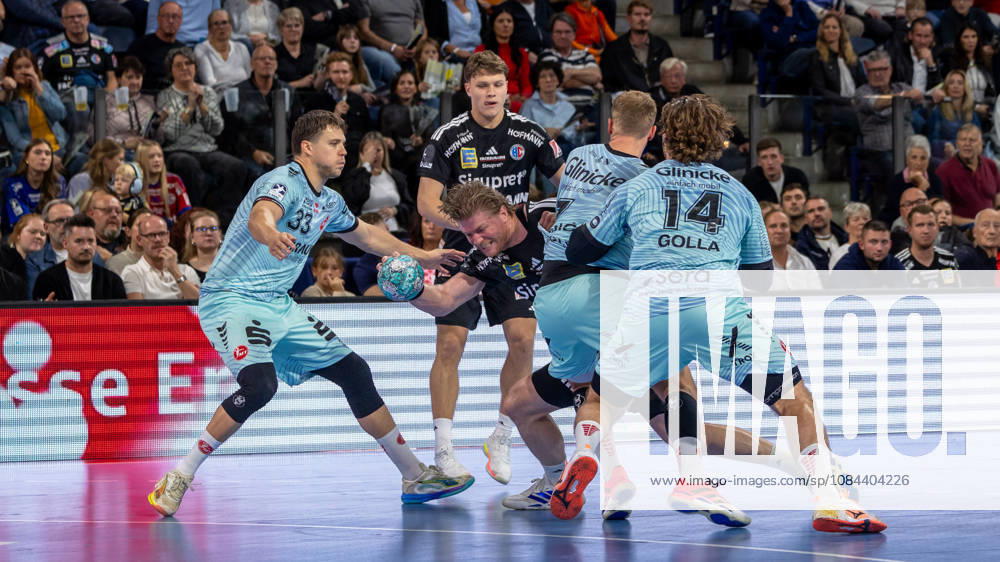 Marek Nissen (HC Erlangen), No. 06, breaks through the block set by Aaron Mensing (MT Melsungen), No. 33, and Johannes Golla (MT Melsungen), No. 14 (GER), HC Erlangen vs. MT Melsungen, Handball, Opel Handball Bundesliga, Matchday 8, 2026–2027 season, October 11, 2026 GER, HC Erlangen vs. MT Melsungen, Handball, Opel Handball Bundesliga, Matchday 8, 2026–2027 season, October 11, 2026 Nuremberg