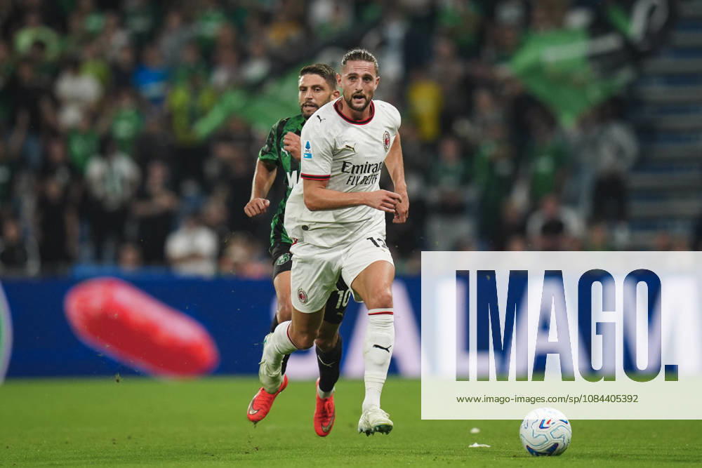 Milan s Adrien Rabiot fights for the ball with Sassuolos Domenico Berardi during the Serie A soccer match between Sassuolo and Milan at the Mapei Stadium in Reggio Emilia, north Italy - Sunday, October 11, 2026 -