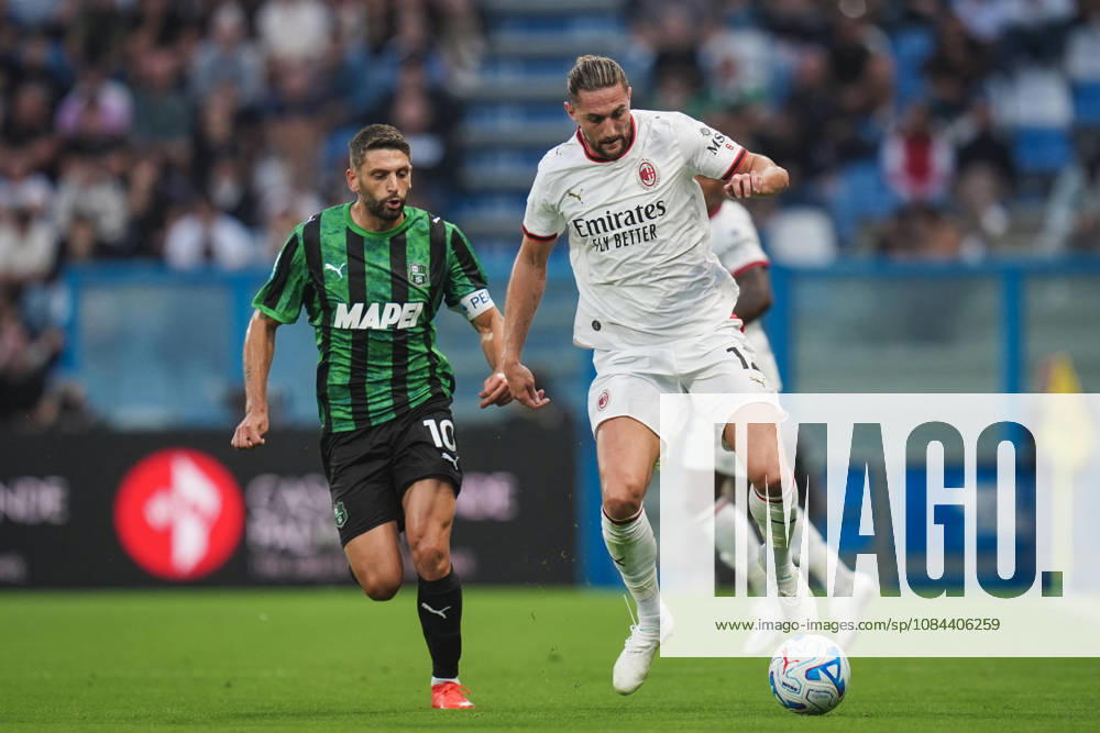 Milan s Adrien Rabiot fights for the ball with Sassuolos Domenico Berardi during the Serie A soccer match between Sassuolo and Milan at the Mapei Stadium in Reggio Emilia, north Italy - Sunday, October 11, 2026 -