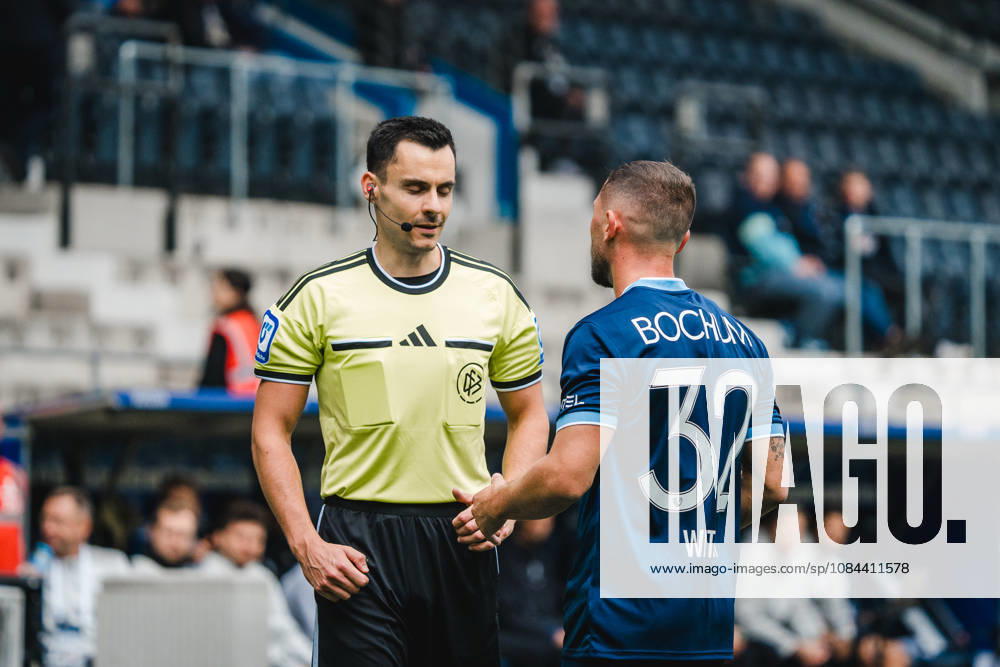 Bochum, Germany, October 11, 2026, 2. Bundesliga 2026–2027, Matchday 7: VfL Bochum 1848 vs. DSC Arminia Bielefeld. Pictured, from left: Referee Konrad Oldhafer and Maximilian Wittek (BOC) in conversation after a foul. DFL DFB regulations prohibit any use of photographs as image sequences and or quasi-video. Vonovia Ruhrstadion, North Rhine-Westphalia