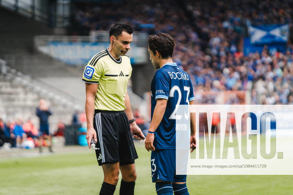 Bochum, Germany, October 11, 2026, 2nd Bundesliga 2026–2027, Matchday 7: VfL Bochum 1848 vs. DSC Arminia Bielefeld. Pictured from left: Referee Konrad Oldhafer in discussion with VfL Bochum player Koji Miyoshi. BOC DFL and DFB regulations prohibit any use of photographs as image sequences and or quasi-video. Vonovia Ruhrstadion, North Rhine-Westphalia