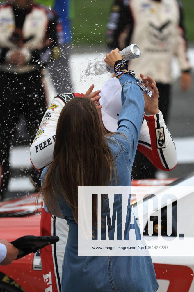 CHARLOTTE, NC - OCTOBER 11: Chase Briscoe ( 19 Joe Gibbs Racing Freebird Spring Water Toyota) celebrates as his wife Marissa pours water on his head after winning the NASCAR, Motorsport, USA Cup Series Playoffs Bank of America 400 race on October 11, 2026 at Charlotte Motor Speedway in Charlotte, NC. (Photo by Jeff Robinson Icon Sportswire) AUTO: OCT 11 NASCAR Cup Series Playoffs Bank of America 400 Icon2610111035400