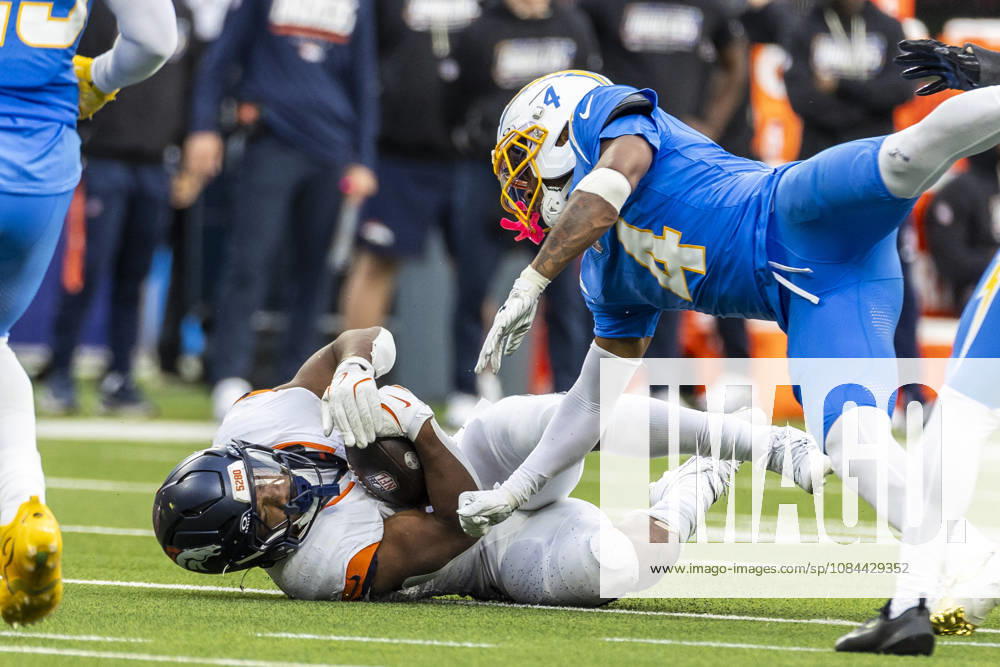 Denver Broncos Running Back J.K. Dobbins (27) is tackled by Los Angeles Chargers cornerback Tarheeb Still (4) during an NFL, American Football Herren, USA football game, in Inglewood, Calif. on Sunday Oct. 11, 2026. Inglewood USA - ZUMAc68_ 20261011_zaf_c68_028