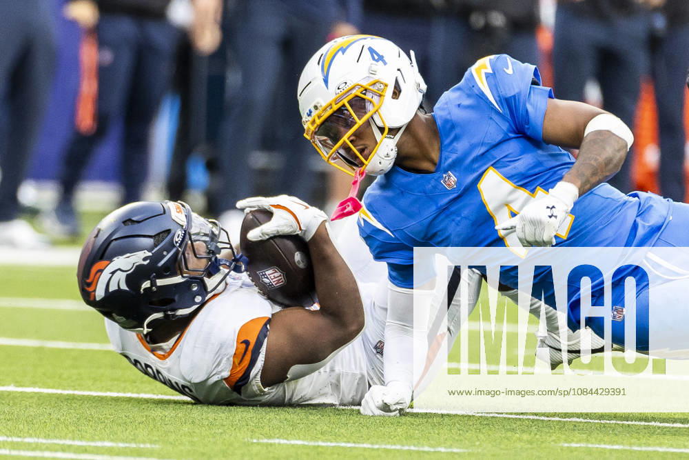Denver Broncos Running Back J.K. Dobbins (27) is tackled by Los Angeles Chargers cornerback Tarheeb Still (4) during an NFL, American Football Herren, USA football game, in Inglewood, Calif. on Sunday Oct. 11, 2026. Inglewood USA - ZUMAc68_ 20261011_zaf_c68_021