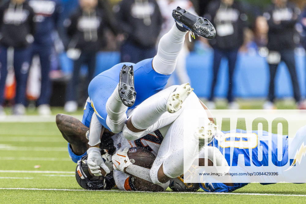 Denver Broncos Running Back J.K. Dobbins (27) is brought down by Los Angeles Chargers linebacker sDel Shawn Phillips (53) and Daiyan Henley (0) during an NFL, American Football Herren, USA football game, in Inglewood, Calif. on Sunday Oct. 11, 2026. Inglewood USA - ZUMAc68_ 20261011_zaf_c68_023
