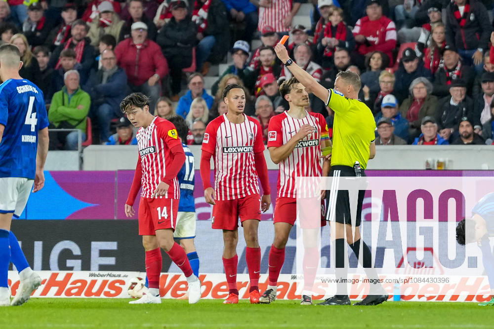 Referee Martin Petersen shows Yuito Suzuki of SC Freiburg, No. 14, a yellow-red card, resulting in his ejection from the game; Germany, soccer, Bundesliga 1, Matchday 5, 2026–2027, SC Freiburg vs. FC Schalke 04, October 11, 2026, Europa-Park Stadium, Freiburg, Baden-Württemberg, Germany