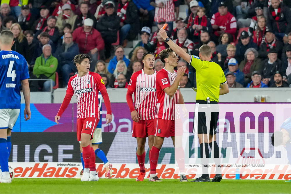 Referee Martin Petersen shows Yuito Suzuki of SC Freiburg, No. 14, a yellow-red card, resulting in his ejection from the game; Germany, soccer, Bundesliga 1, Matchday 5, 2026–2027, SC Freiburg vs. FC Schalke 04, October 11, 2026, Europa-Park Stadium, Freiburg, Baden-Württemberg, Germany