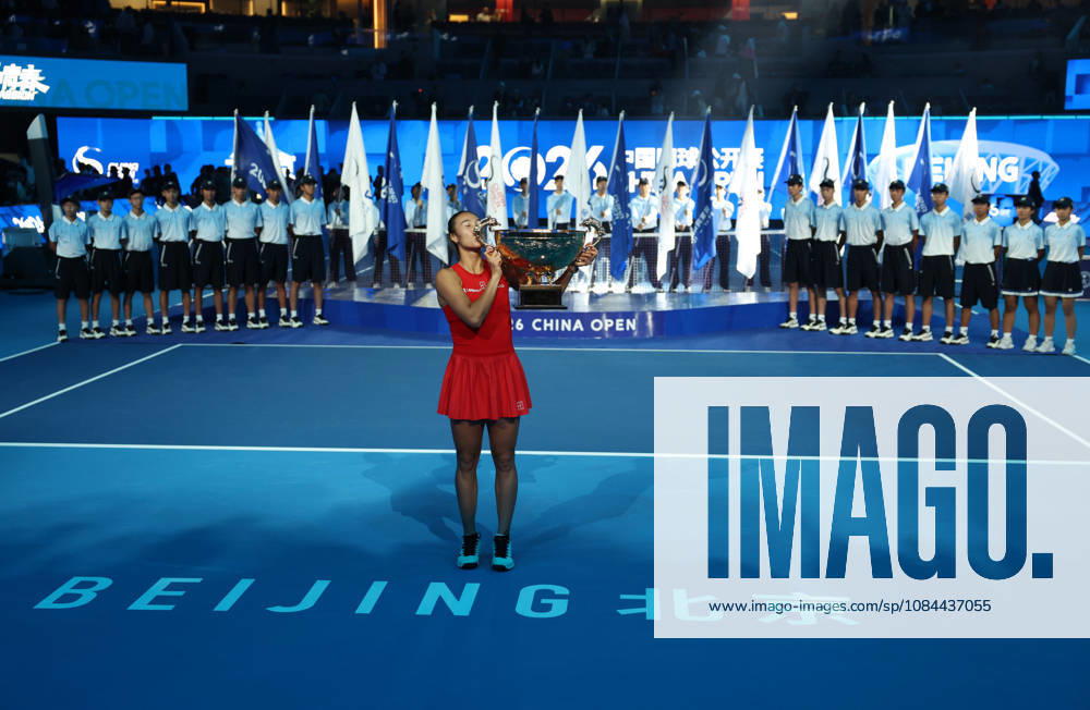 (261012) -- BEIJING, Oct. 12, 2026 -- Zheng Qinwen kisses the trophy during the awarding ceremony after the women s singles final between Zheng Qinwen of China and Mirra Andreeva of Russia at 2026 China Open tennis tournament in Beijing, China, Oct. 11, 2026. ) XINHUA PHOTOS OF THE DAY ZhangxChenlin