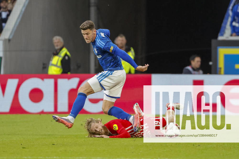 Niklas Beste of SC Freiburg, 19, and Robin Gosens of FC Schalke 08 in a tackle, Germany, soccer, Bundesliga 1, Matchday 5, 2026–2027, SC Freiburg vs. FC Schalke 04, October 11, 2026, Freiburg im Breisgau, Europa-Park Stadium, Germany