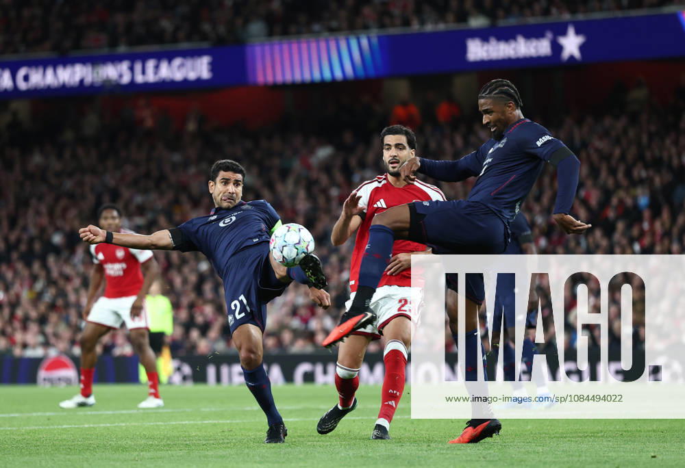 London, England, 13th October 2026. Benjamin Andre of LOSC Lille (l) and Alexsandro of LOSC Lille (r) clear the ball under pressure from Mikel Merino of Arsenal (c) during the Arsenal vs LOSC Lille UEFA Champions League match at the Emirates Stadium, London. Picture credit should read: David Klein Sportimage . SPI_035_DK_Arsenal_Lille SPI-5065-0036