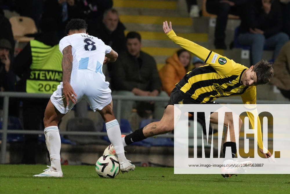 Marc Gual of Kairat and Iago Siqueira of Riga FC compete for the ball during a UEFA Conference League soccer match between Latvias Riga FC and Kazakhstans Kairat Almaty at Skonto Stadium in Riga, Latvia, Thursday, Oct. 15, 2026. Riga Latvia