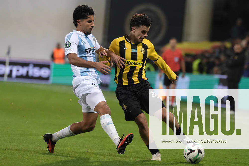 Gustavo Mendonca of Kairat and Salah Oulad M Hand of Riga FC compete for the ball during a UEFA Conference League soccer match between Latvias Riga FC and Kazakhstans Kairat Almaty at Skonto Stadium in Riga, Latvia, Thursday, Oct. 15, 2026. Riga Latvia