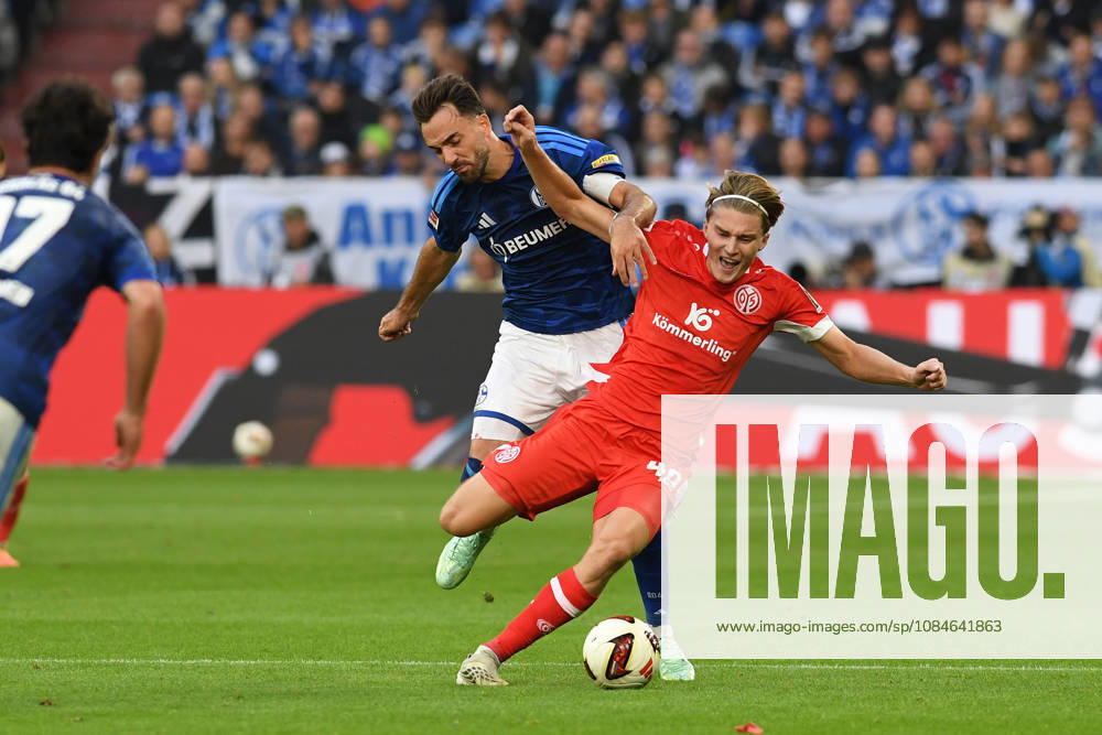 Kenan Karaman of FC Schalke 04 and Kacper Potulski of 1. FSV Mainz 05 go head-to-head during the Bundesliga match between FC Schalke 04 and 1. FSV Mainz 05, Veltins Arena on October 17, 2026, in Gelsenkirchen, Germany. Photo by Ralf Treese, DeFodi Images. Kenan Karaman of FC Schalke 04 and Kacper Potulski of 1. FSV Mainz 05 battle for the ball during the Bundesliga match between FC Schalke 04 and 1. FSV Mainz 05 at Veltins Arena on October 17, 2026 in Gelsenkirchen, Germany. Photo by Ralf Treese, DeFodi Images. DFB and DFL regulations prohibit any use of photographs as image sequences and or quasi-video. Photo by Ralf Treese, DeFodi Images.