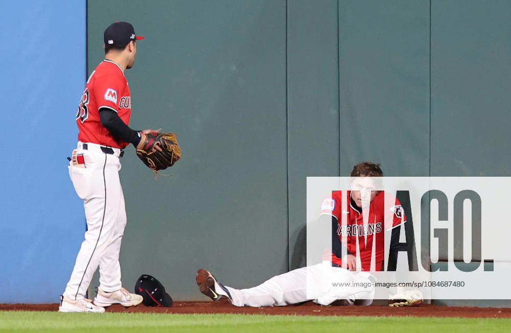 Cleveland Guardians center fielder Petey Halpin (R) sits on the ground after going up against the wall to catch a long fly ball from Tampa Bay Rays Junior Caminero as left fielder Steven Kwan (38) assists in the fourth inning during game four of the MLB, Baseball Herren, USA American League Championship Series at Progressive Field in Cleveland, Ohio, on Saturday, October 17, 2026. CLE20261017714 AARONxJOSEFCZYK