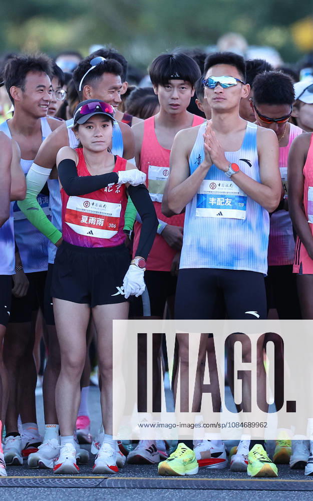 (261018) -- BEIJING, Oct. 18, 2026 -- Runners Feng Peiyou (front R) and Xia Yuyu (front L) prepare before the 2026 Beijing Marathon & National Marathon Championships in Beijing, capital of China, Oct. 18, 2026. ) (SP)CHINA-BEIJING-2026 BEIJING MARATHON(CN) LixMing