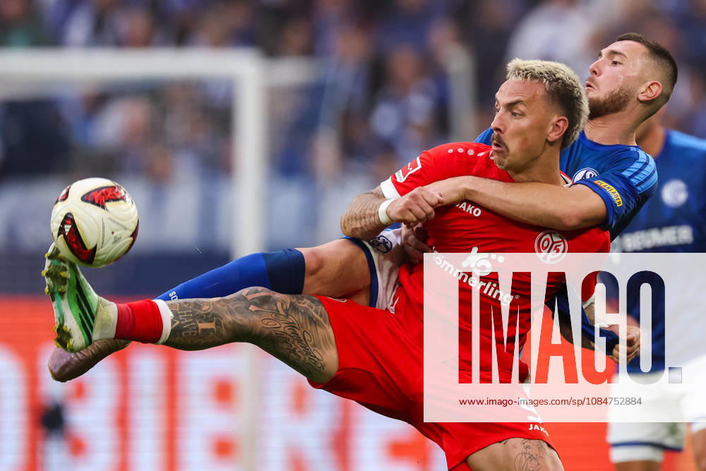Phillip Tietz of 1. FSV Mainz 05 and Hasan Kurucay of FC Schalke 04 battle for the ball during the Bundesliga 2026 27 match between FC Schalke 04 and 1. FSV Mainz 05 at Veltins-Arena on October 17, 2026 in Gelsenkirchen, Germany.