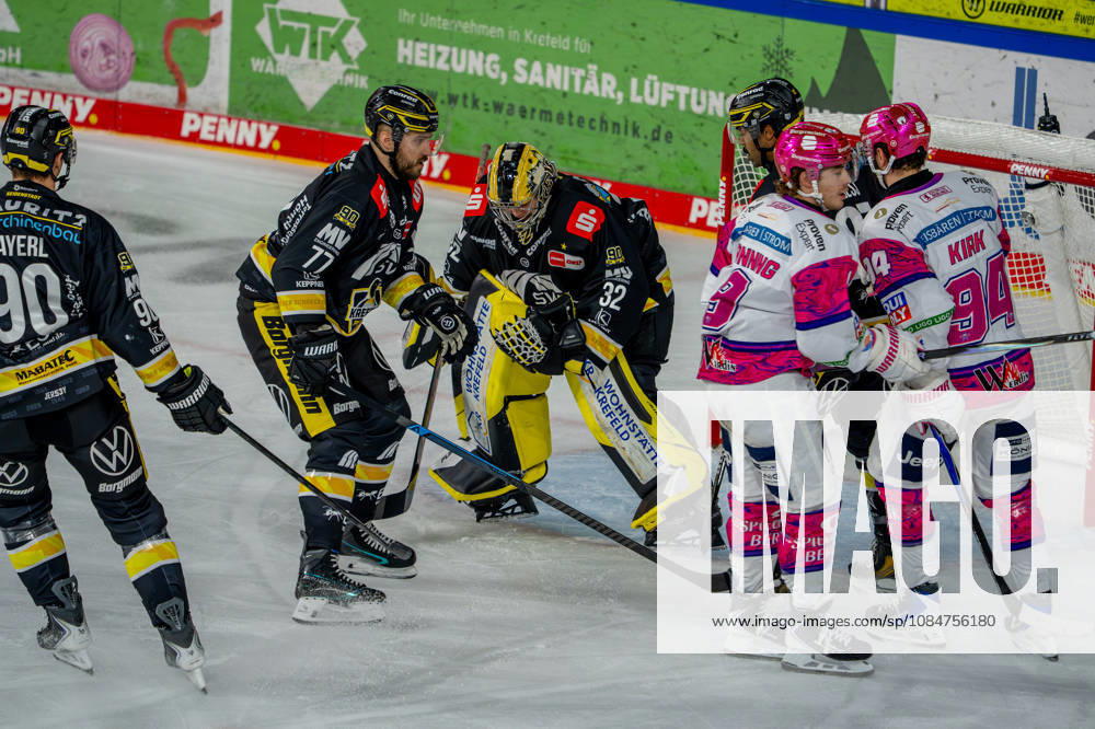 Ice Hockey, DEL, Krefeld Pinguine vs. Eisbären Berlin, 2026–27 Season, YAYLA Arena, Krefeld: Goalie Juha Jatkola (Krefeld Pinguine, 32) makes a save against Ty Ronning (Eisbären Berlin, 09) and Liam Kirk (Eisbären Berlin, 94) in North Rhine-Westphalia, Germany