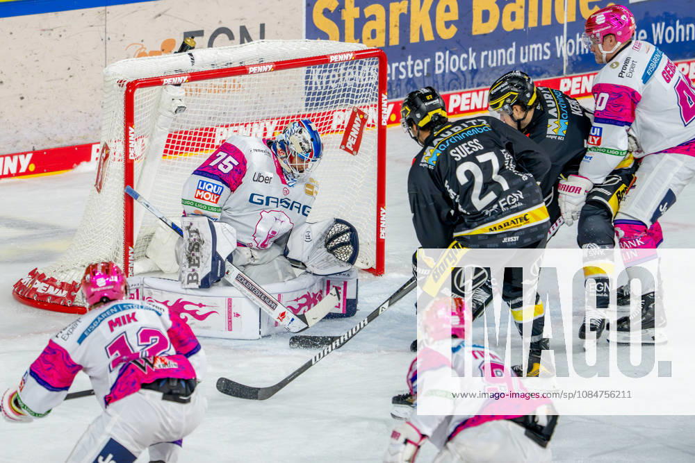 Ice Hockey, DEL, Krefeld Pinguine vs. Eisbären Berlin, 2026–27 Season, YAYLA Arena, Krefeld; C. J. Suess (Krefeld Pinguine, No. 27) alongside Erik Buschmann (Krefeld Pinguine, No. 15) in a one-on-one battle against goalie Jonas Neffin (Eisbären Berlin, No. 75); North Rhine-Westphalia, Germany