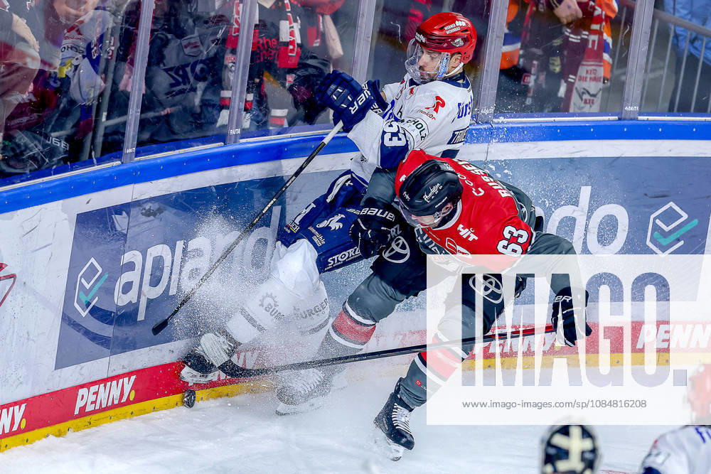 Ice Hockey, DEL, Kölner Haie vs. Schwenninger Wild Wings, Matchday 49, 2026–27 Season, Lanxess Arena, Cologne: Alex Trivellato (SWW 53) battles Patrick Russell (Cologne Sharks 63) for the puck along the boards in North Rhine-Westphalia, Germany