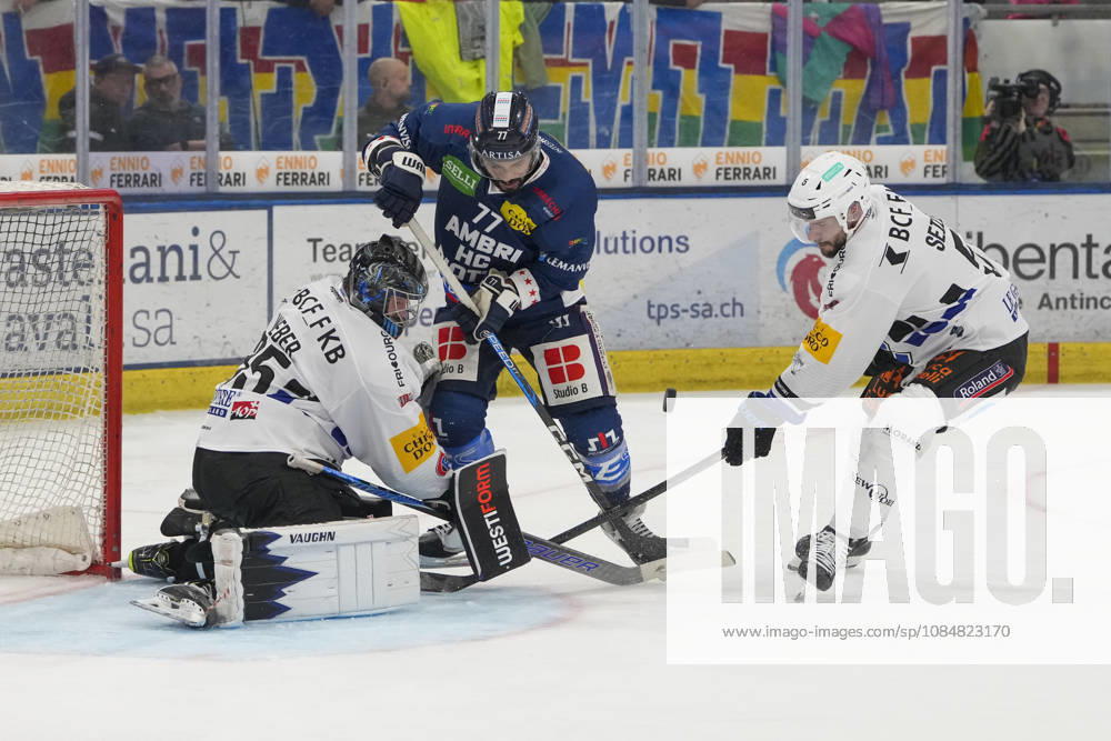 QUINTO, SWITZERLAND, OCTOBER 20: Michael Joly of Ambri C battles goalkeeper Ludovic Waeber of Fribourg and Simon Seiler of Fribourg R during the game between HC Ambri Piotta and Fribourg Gotteron at the Gottardo Arena on October 20, 2026 in Quinto, Switzerland; Quinto, Ticino, Switzerland