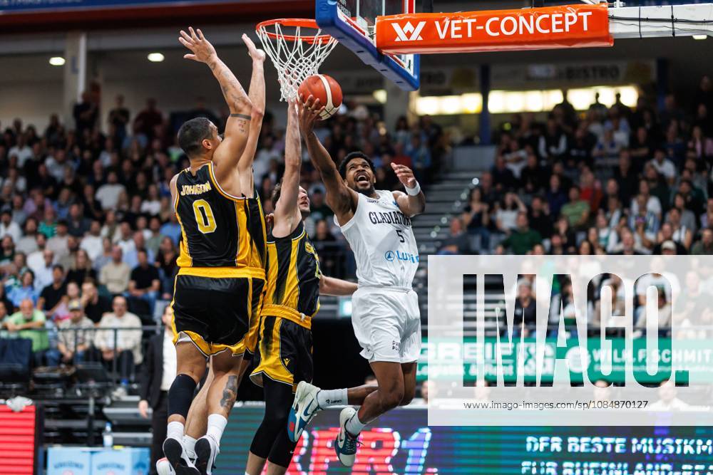 Justin Simon of the Gladiators Trier battles for the ball under the basket against Nick Johnson of KK Croatia Split and Mindaugas Kacinas of KK Croatia Split; action from the Vet Concept Gladiators Trier vs. KK Split game, basketball, FIBA Europe Cup, Matchday 3, 2026–2027 season, October 21, 2026, Vet Concept Gladiators Trier vs. KK Split, Basketball, FIBA Europe Cup, Matchday 3, 2026–2027 Season