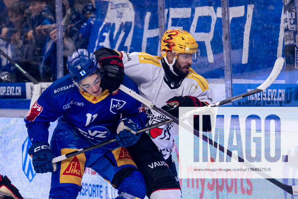 Nik Petrovic 11, EV Zug, in a one-on-one battle with PostFinance s top scorer Jason Fuchs, Lausanne HC 23, 10, 2026, National League, Regular Season, Ice Hockey, OYM Hall, Zug EV Zug vs. Lausanne HC. Image by