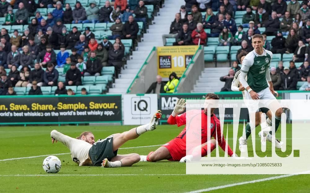 Kasper Hogh of Celtic slides but fails to make contact with the ball in front of Hibernian goalkeeper Raphael Sallinger Hibernian v Celtic, William Hill Scottish Premiership, Football, Easter Road, Edinburgh, Scotland, UK - 25 Oct 2026Edinburgh Easter Road Scotland United Kingdom