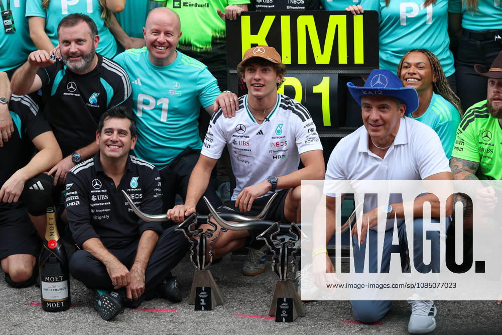 AUSTIN, TX - OCTOBER 25: Andrea Kimi Antonelli (12) of Italy and Mercedes-AMG PETRONAS Formula One Team kneels with his championship trophy as his dad Marco Antonelli sits by his side after winning the Formula 1 MSC Cruises United States Grand Prix on October 25, 2026, at Circuit of The Americas in Austin, Texas.(Photo by David Buono Icon Sportswire) AUTO: OCT 25 F1 United States Grand Prix Icon2610250811